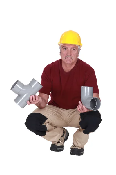 Plumber with plastic pipes — Stock Photo, Image