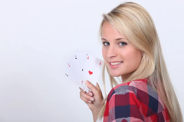 Blond teenage girl playing cards — Stock Photo, Image