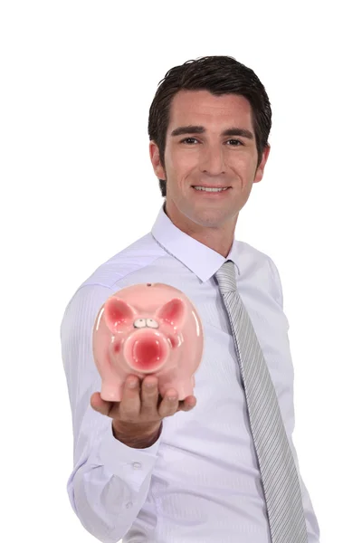 Человек, держащий банк свиньи — стоковое фото