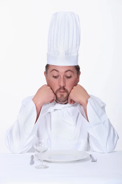 Mužský kuchař vypadá velmi nešťastně — Stock fotografie