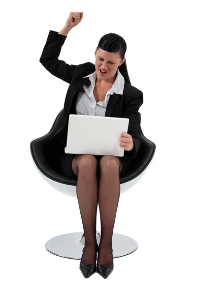 Excited businesswoman pumping fist in the air — Stock Photo, Image