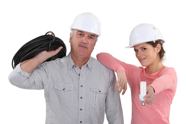 Experienced electrician and young female apprentice — Stock Photo, Image