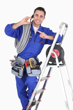 Electrician surrounded by equipment clipart