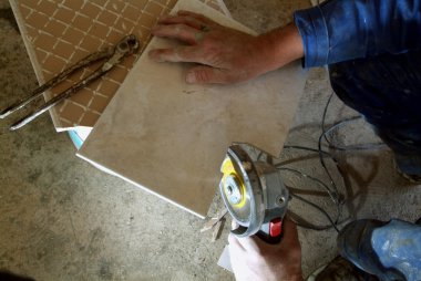 Man cutting a tile clipart