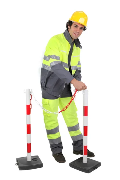 Construction worker putting up a barrier — Stock Photo, Image