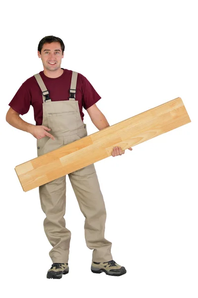 Řemeslník drží dřevěné desky — Stock fotografie