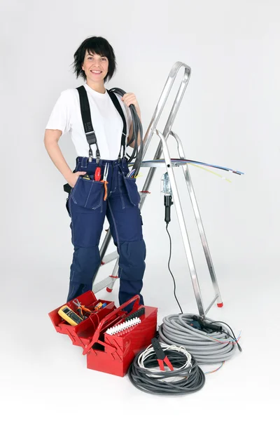 Female electrician stood by ladder — Stock Photo, Image