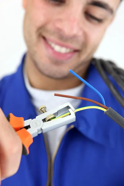 Electrician with a wire stripper — Stock Photo, Image