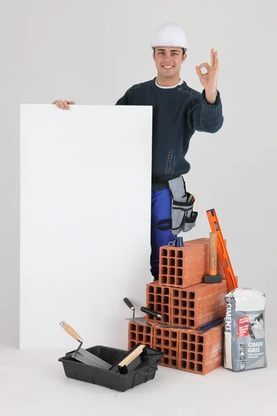 OK from a bricklayer with a blank board — Stock Photo, Image