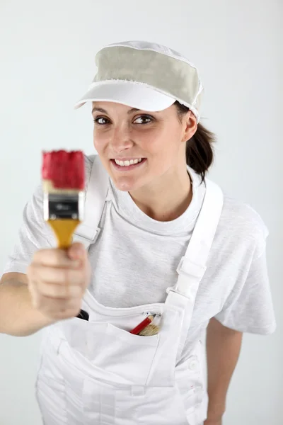 Female decorator holding a paint brush — Stock Photo, Image