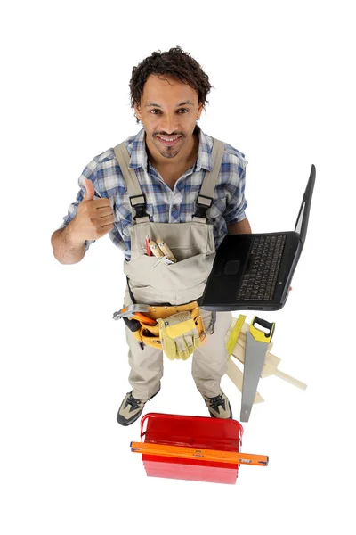 Handyman with a laptop — Stock Photo, Image