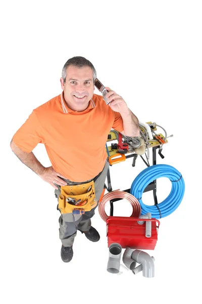 Plumber talking on his cell — Stock Photo, Image