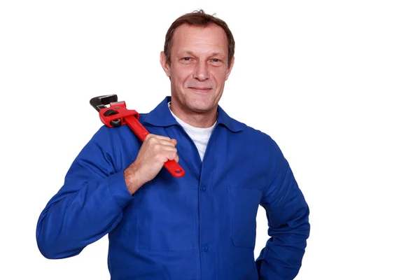 Portrait of mature plumber holding adjustable spanner — Stock Photo, Image