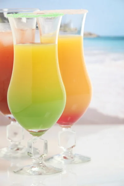 Three colorful cocktails on the beach — Stock Photo, Image