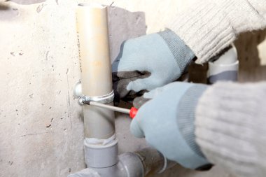 Plumber installing pipes clipart