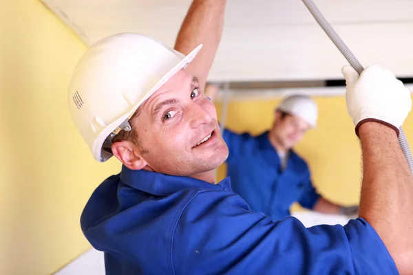 Two plumbers repairing ceiling — Stock Photo, Image