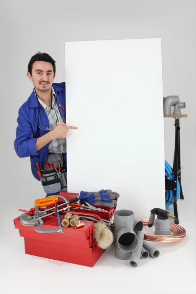 Plumber pointing wall — Stock Photo, Image