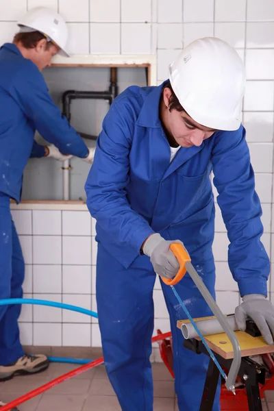 Two plumbers hard at work — Stock Photo, Image