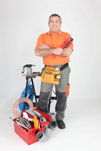Studio shot of a plumber with tools of the trade — Stock Photo, Image