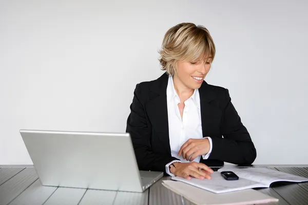 그녀의 책상에서 떨어져 근무 하는 금발 여자 — 스톡 사진