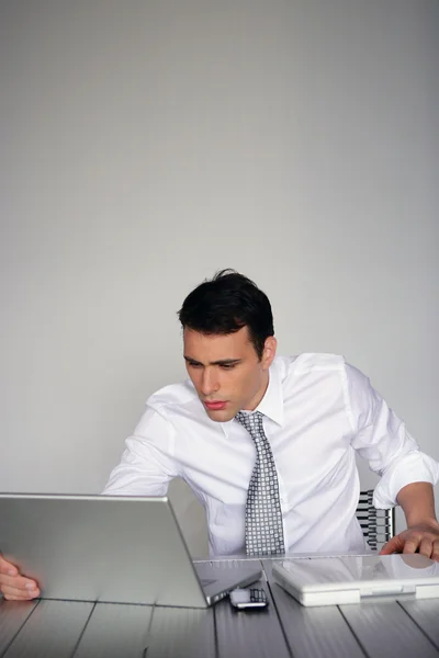 Determined businessman sat at his desk — Stock Photo, Image