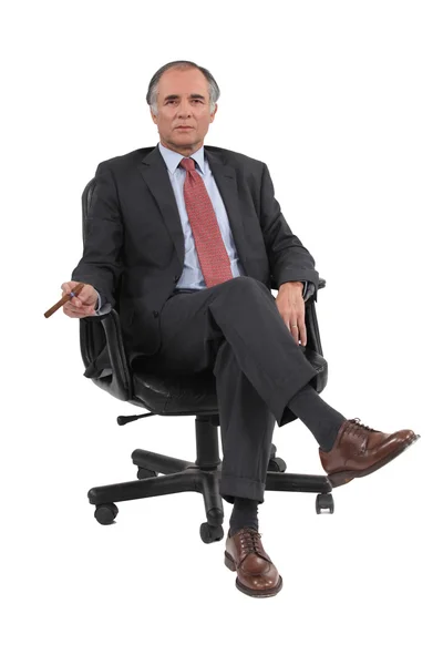 Businessman sitting in a swivel chair — Stock Photo, Image