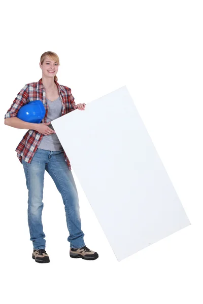 Woman laborer holding white board — Stock Photo, Image