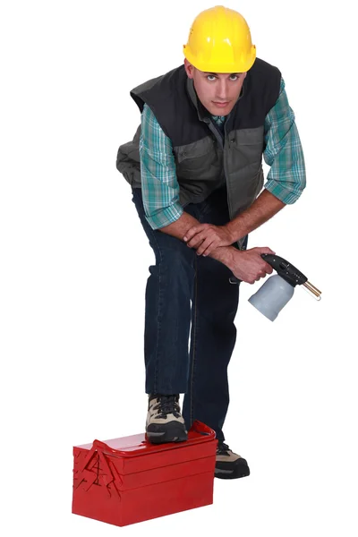 Plumber with leg resting on toolbox — Stock Photo, Image