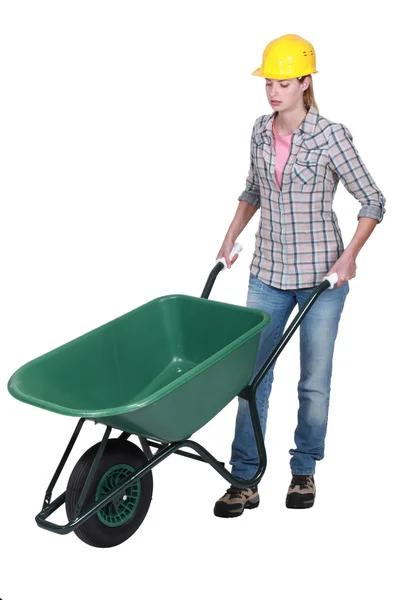 Female construction worker with a wheelbarrow — Stock Photo, Image