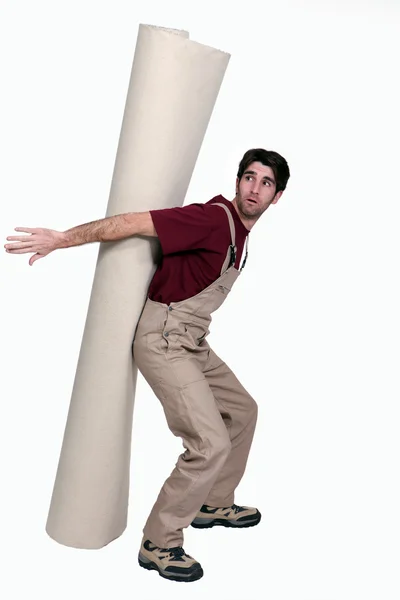 Full-length shot of craftsman with linoleum roll — Stock Photo, Image