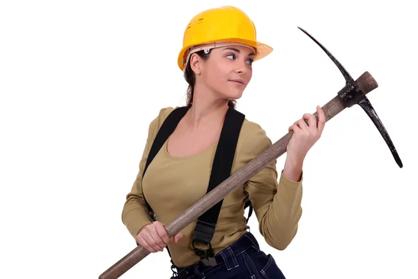 Young woman holding pickaxe — Stock Photo, Image
