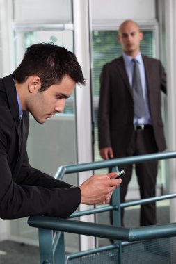 Man making a personal call at work clipart