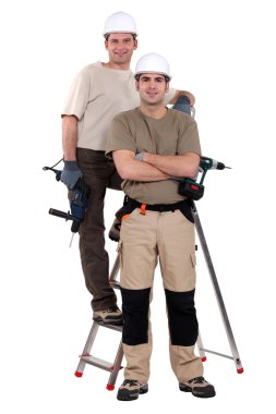 Two electricians stood with ladder clipart