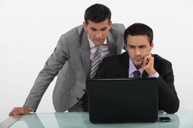 Business associates reading a distressing e-mail clipart