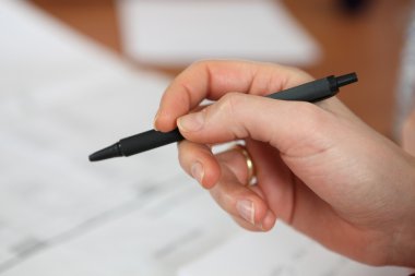 Closeup of a hand holding a pen clipart