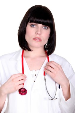 Worried doctor with a stethoscope around her neck clipart