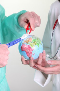 Medical staff operating on globe clipart