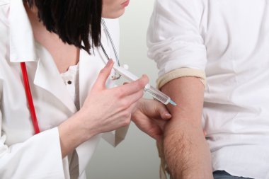 A nurse giving an injection clipart