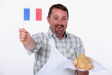 Frenchman proudly waving the flag over his uncooked French chicken clipart