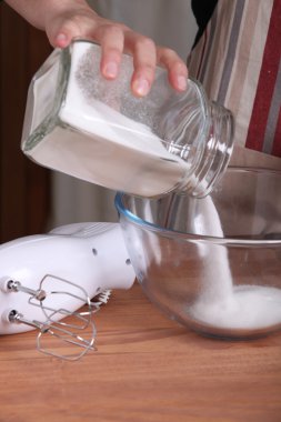 Man pouring sugar into bowl clipart