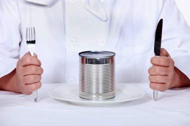 Chef sitting down to a tin can meal clipart