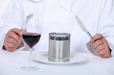 Chef sitting down to a canned dinner clipart