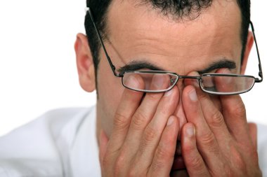 Tired man rubbing his eyes clipart