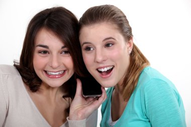 Women excitedly listening to a song clipart