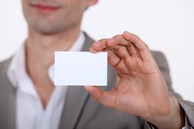 Close-up of businessman with card clipart