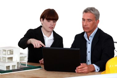 Architects with a laptop and 3D model clipart