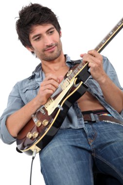 Young man playing guitar clipart