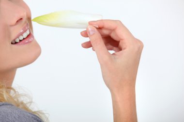 Woman eating endives clipart