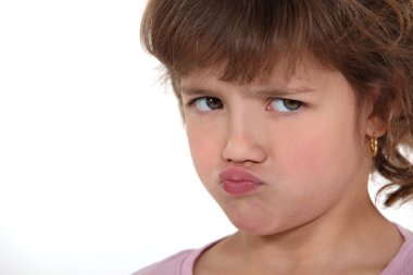 A little girl sulking. clipart