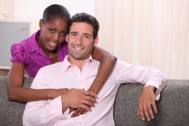 Mixed race couple at home clipart
